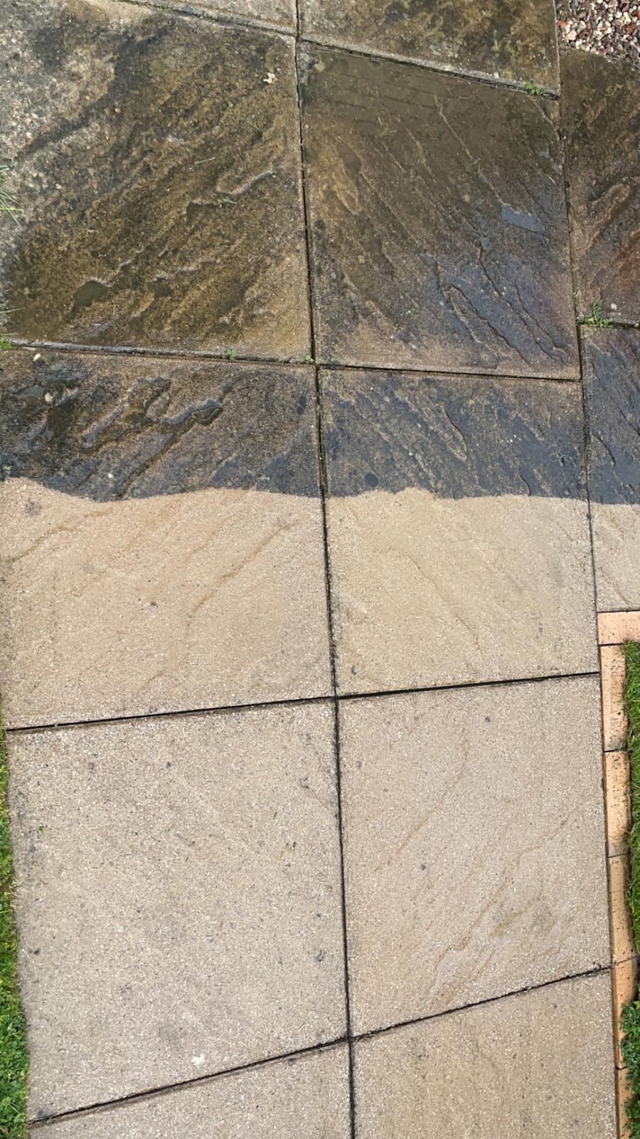 Sandstone patio half-cleaned showing dramatic before and after